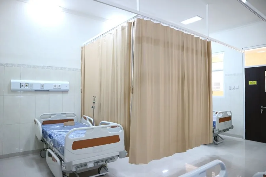 Empty recovery bays separated by privacy curtains in a day-surgery unit